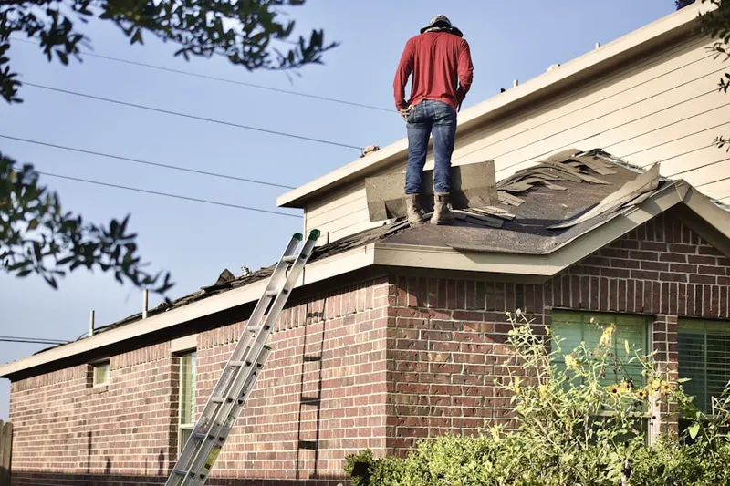 Professional roofer working on a residential roof in Lockmar Acres